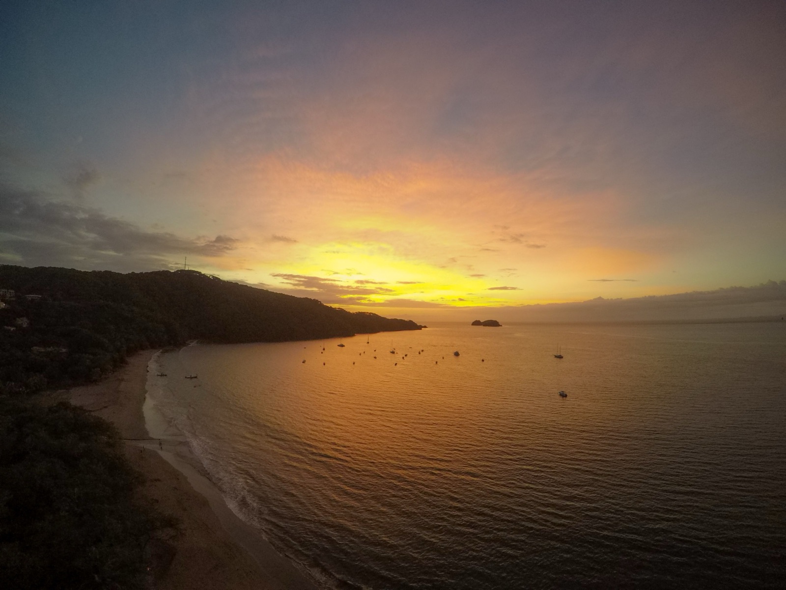 Sunset over Playa Hermosa, Guanacaste, with boats at anchor