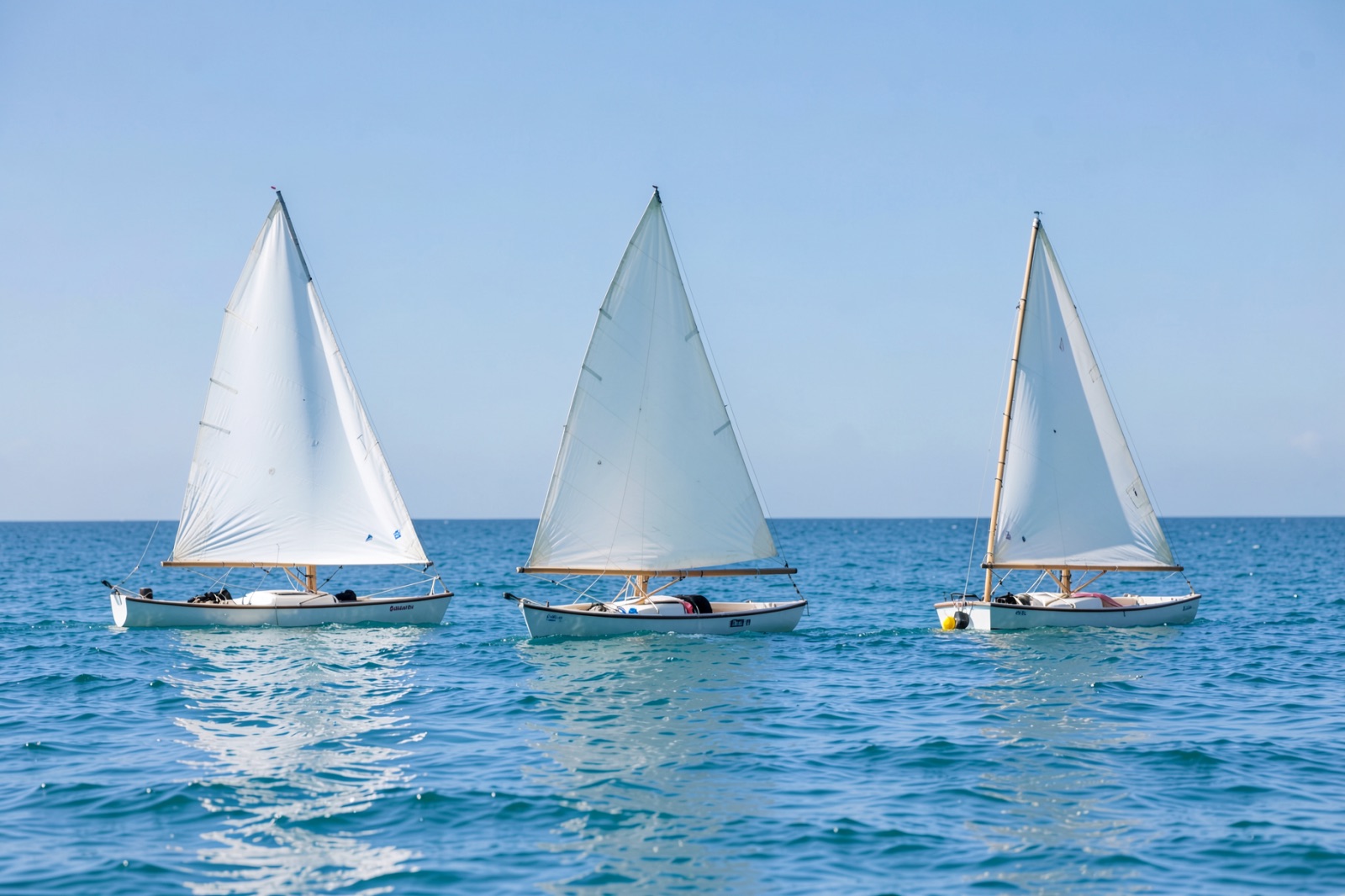 Small sailing dinghies on calm water